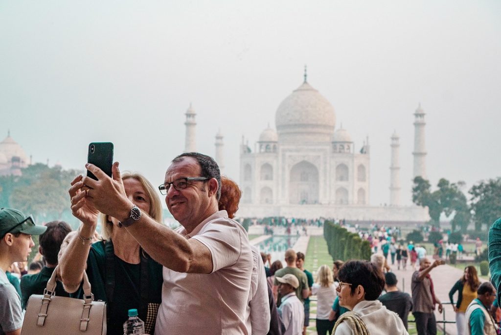 Travellers taking selfie at Taj Mahal